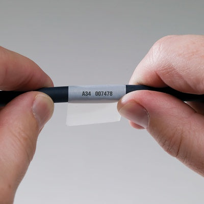 Self-laminating wrap-around wire and cable labels printed with legends