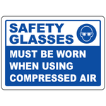 Safety glasses required sign with mandatory eye protection symbol for compressed air use