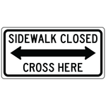 Sidewalk closed cross here double arrow sign guiding pedestrians to crossing area