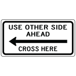 Use other side ahead cross here left sign directing pedestrians to safe crossing area