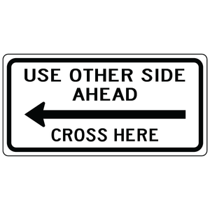 Use other side ahead cross here left sign directing pedestrians to safe crossing area