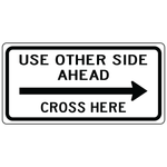 Use other side ahead cross here right sign guiding pedestrians safely across road